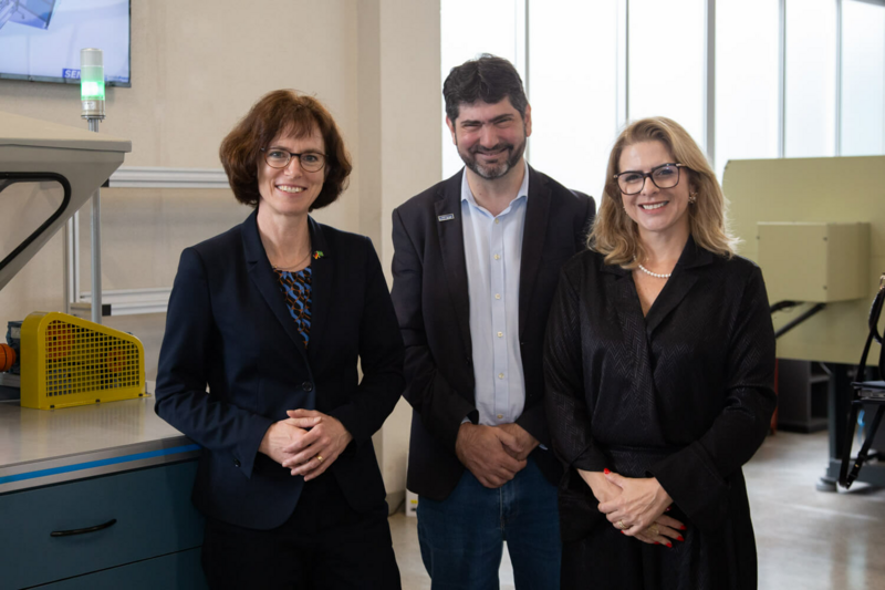 Three people smiling at the camera.